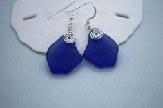 "Striking Cobalt Blue Sea Glass Earrings, Seaglass Earrings, Sea Glass Jewelry, Beach Glass Earrings, Beach Jewelry, Seaglass Jewelry, Ocean Jewelry Hawaiian Jewelry, Hawaii Jewelry, Made on Maui by U'i Jewelry. Alohi Earrings (ah low hee) * To Shine These everyday earrings were created using cobalt blue colored cultured sea glass that I have wire wrapped and made into a unique and simple pair of earrings. They are a perfect for everyday wear or that special occasion. Sea glass shape in image on Jewelry Ocean, Hawaii Jewelry, Earrings Beach, Hawaiian Jewelry, Jewelry Beach, Ocean Jewelry