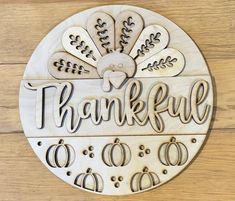 a wooden plaque with the words, thank you and an image of a turkey on it