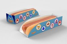 two hotdogs with different toppings are in a carton on a white surface