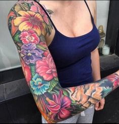 a woman with tattoos on her arms and arm