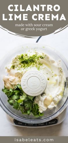 the ingredients for cilantro lime cream in a food processor with text overlay