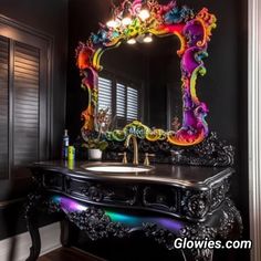 a bathroom with a sink, mirror and lights on the wall above it is decorated in black