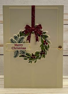 a christmas card with a wreath on it