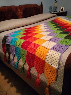 a crocheted blanket on top of a bed