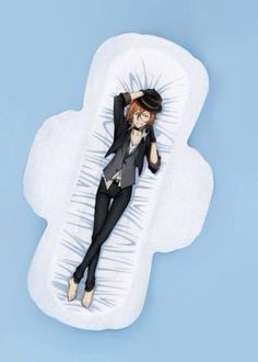 a woman laying on top of a cloud shaped pillow