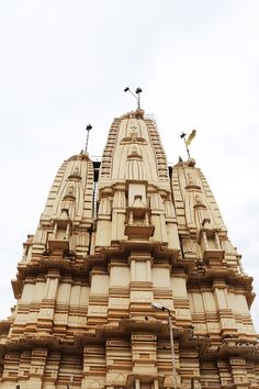 an ornate building with birds perched on the top