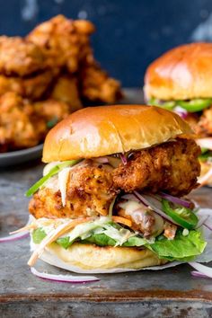 two chicken burgers with lettuce and tomato slaw