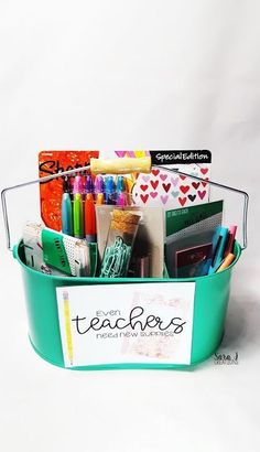 a green bucket filled with pens, markers and other office supplies sitting on top of a white surface