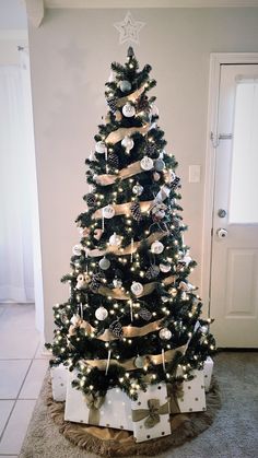 a decorated christmas tree with presents under it