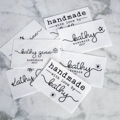 four handmade labels on a marble surface