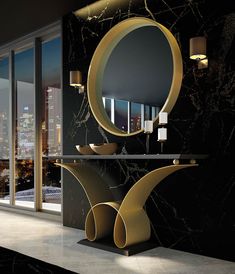 an elegant bathroom with black marble walls and flooring, along with round mirrors on the wall