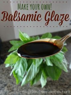 a spoon full of balsamic glaze on top of a green leafy plant