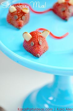 strawberries shaped like mice on a blue cake plate with text overlay that reads, strawberry mouse