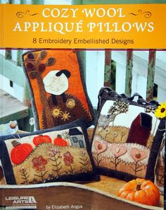 the book cozy wool applique pillows and embroidery embellished designs is on display