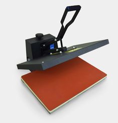 an image of a heat press machine on a red mat