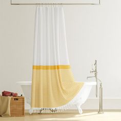 a bathroom with a white tub and yellow shower curtain