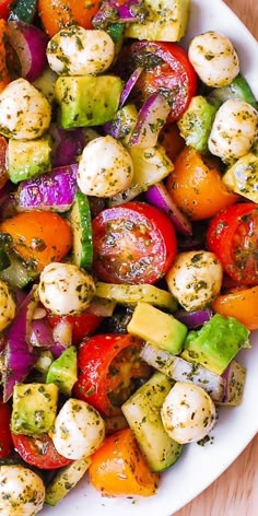 a white bowl filled with vegetables on top of a wooden table