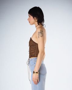 Have their stomach tied up in knots when you walk by wearing this brown lace up top 💅 Constructed from stretch sueded fabric, this top features a strapless form fitting design, a lace up front, and a center back zipper 🤎 Fitted Brown Bandeau Tube Top, Strapless Brown Tube Top For Night Out, Spring Brown Stretch Tube Top, Brown Stretch Tube Top For Spring, Fitted Brown Tube Top For Spring, Brown Strapless Crop Top, Fitted Brown Bandeau Crop Top, Black Off Shoulder Top, Lace Up Top