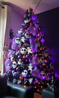 a decorated christmas tree with purple lights and skulls