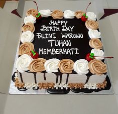 a birthday cake with white and brown frosting