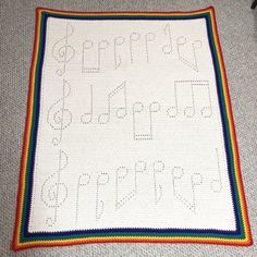 a crocheted blanket with letters and numbers on it