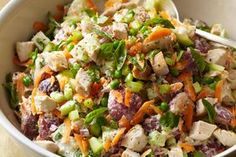 a salad with chicken, carrots and celery in a bowl