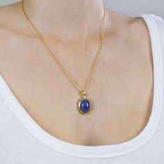 A delicate balance of rich blue and violet, this gem has fine crystal inclusions and an exquisite luster. Wearing this deep blue-hued beauty will add an elegant touch to any outfit. Known as the ‘stone of magic’ it brings its wearer the confidence to turn ideas into reality. Bringing the “will” to start and enhancing from beginning to end. This Tanzanite cabochon stone necklace is also great for Communication and Protection. Stone Origin: ﻿Tanzania Measures Approximately: 22 x 18 mm Materials: Hand Crafted 925 Sterling Silver with a 14k Yellow Gold Vermeil Finish and Gold Fill Box chain Please Note: If you would like to purchase a different chain please purchase pendant only and click here. All pieces shipped within 48 hours from our Del Mar Gallery. Elegant Sapphire Jewelry With Natural Stones, Yellow Gold Tanzanite Oval Necklace, Sapphire Necklaces With Natural Stones, Sapphire Tanzanite Birthstone Necklaces, Sapphire Necklace With Natural Stones, Elegant Sapphire Necklaces With Natural Stones, Elegant Oval Tanzanite Necklaces, Tanzanite Gemstone Pendant Necklaces, Tanzanite Gemstone Pendant Necklace