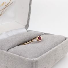 A dainty east west ring is perfect for the minimalist in your life or for giving someone their first piece of jewelry :) This ruby presents a mixture of red hues which is perfectly accentuated by two diamonds on each side. The slim yellow gold shank provides a lightweight, effortless look! This ring is made with solid 14K Gold and natural Earth mined SI / G-H diamonds. As listed, this ring is ready to ship. If you're interested in purchasing this setting with a different center stone please mess Red 14k Gold Dainty Birthstone Ring, Dainty Red Birthstone Ring In 14k Gold, Dainty Ruby Ring With Rose Cut Diamonds, Minimalist Oval Ruby Wedding Ring, Minimalist Red Birthstone Ring In 14k Gold, Red Oval Stackable Promise Rings, Minimalist 14k Gold Red Ruby Ring, Minimalist 14k Gold Ring In Red, Minimalist Oval Ruby Ring For Anniversary