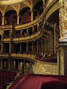 an ornately decorated auditorium with red velvet seats