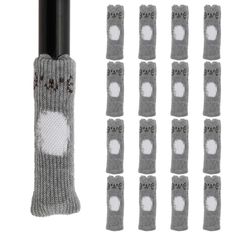 several pairs of gray socks with white dots on them and one pair of black poles