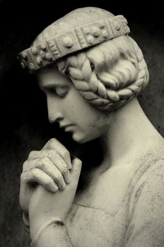 a black and white photo of a woman with braids on her head wearing a hat