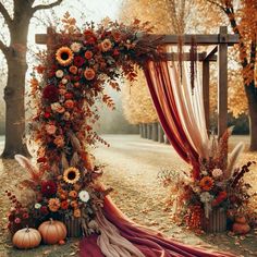 an outdoor wedding arch decorated with flowers and sunflowers in fall, surrounded by pumpkins