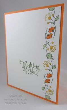 an orange and white card with flowers on it