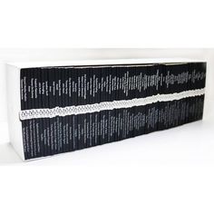 the black and white books are lined up on top of each other in front of a white background