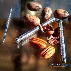 nuts and nutcrackers sitting on a table next to a metal barbwire