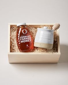 a wooden box with a honey jar in it