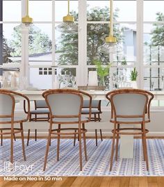 a dining room table and chairs in front of large windows