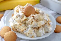 a white plate topped with dessert next to bananas