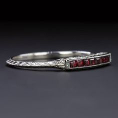 a silver ring with red stones on it