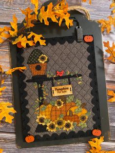 an autumn scene with sunflowers, pumpkins and a birdhouse hanging on a wall