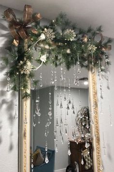 a mirror with christmas decorations hanging from it