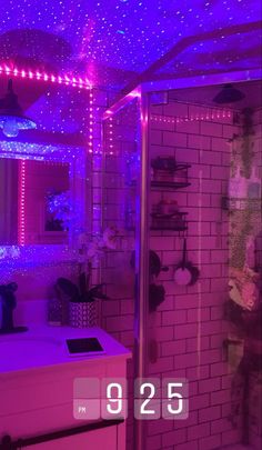 the bathroom is lit up with purple lights