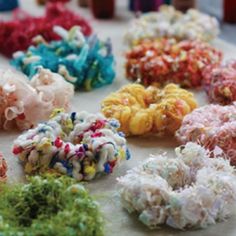 many different types of hair scrunffles on a table