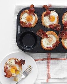 an egg and bacon muffins in a muffin tin with a fork on the side