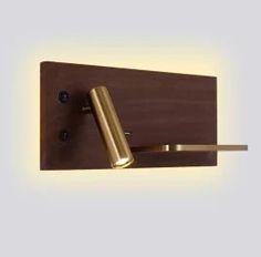 a light that is on the side of a wooden wall mounted fixture with a metal handle