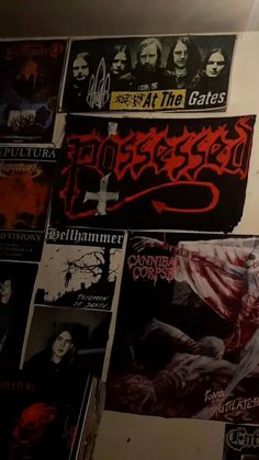 a wall covered in posters and stickers with the words hellhammer written on them