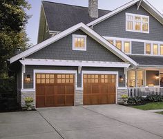 a large house with two garages in front of it