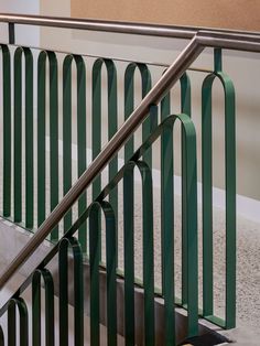 an escalator with metal handrails next to a concrete floor and wall