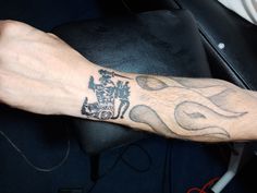 a man's arm with a tattoo on it that has a coat of arms