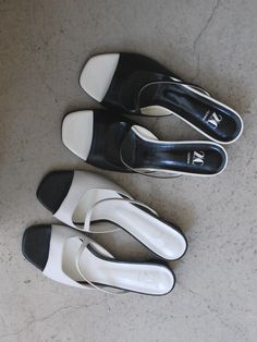 Editor's Notes2comm presents lovely and feminine footwear that is comfortable and practical. - Open square toes- Open upper with cut straps- Contrasting black & white- Wide and low heels- Classic and feminine mood Measurements (in.)- Size: KR 225MM (US 5.5) ~ KR 250MM (US 8)- Heel: 1.18 in.*Fit true to size Composition & Care- Material: Cow Leather- Natural leather may have fine scratches and wrinkles- Bright leather can get stained by denim or dark outfits- Pen and bond m White Low Heel Mules With Heel Strap, Classic White Sandals With Medium Width, White Sandals With Contrasting Heel And Single Toe Strap, Classic White Low Heel Sandals, Modern White Sandals With Low Heel, Classic White Sandals With Low Heel, Modern White Mules Medium Width, Modern White Mules Of Medium Width, White Square Toe Mules With Branded Heel